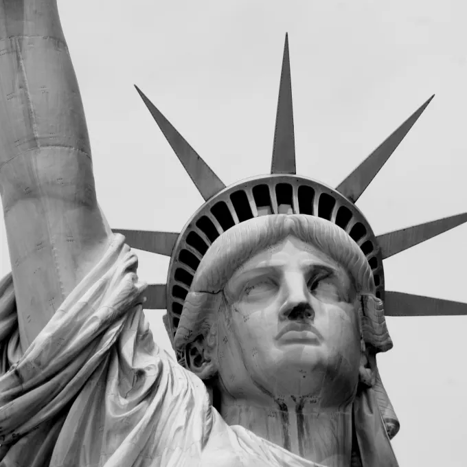 black and white photo of statue of liberty head and arm