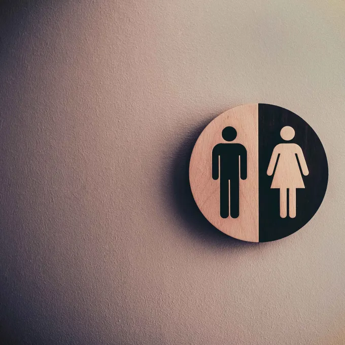 a wall sign depicting male and female figures